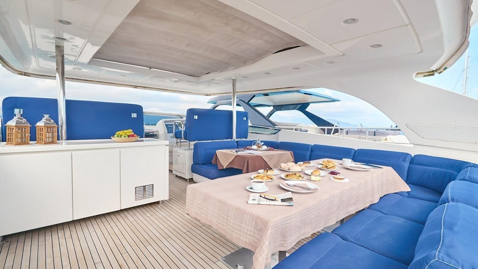 a room with a table and chairs aboard SUNRAY II Yacht for Sale