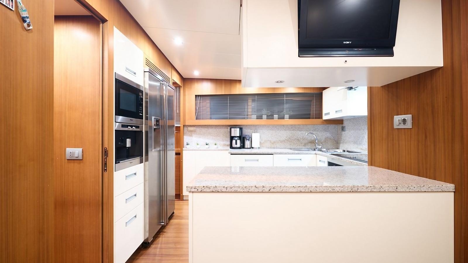 a kitchen with a microwave oven and a sink aboard SUNRAY II Yacht for Sale