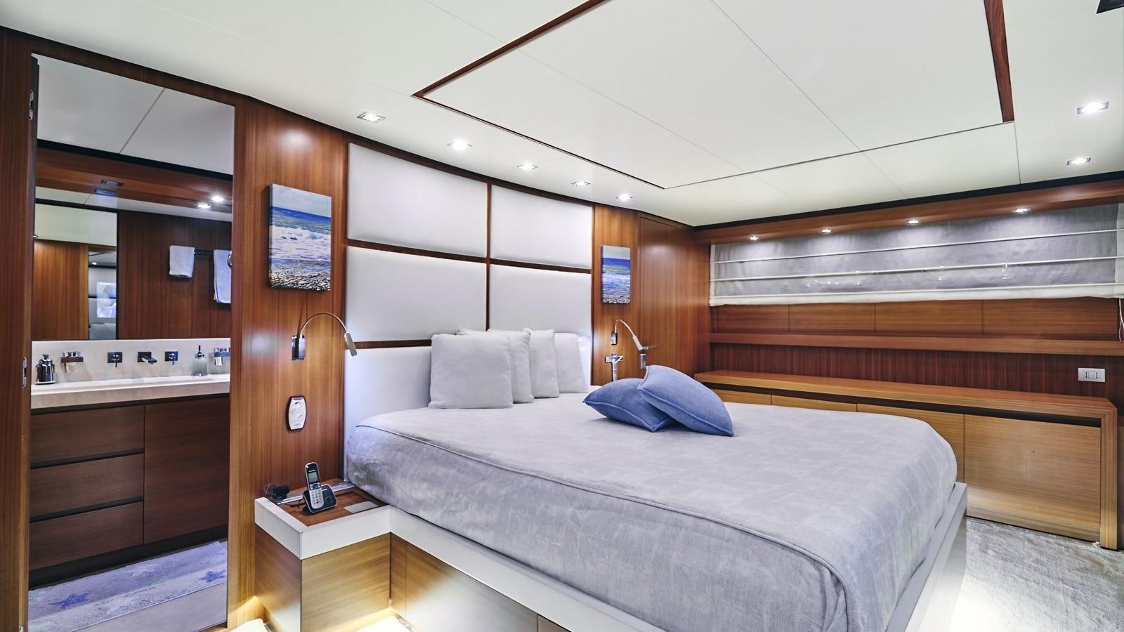 a bedroom with a bed and a wood wall aboard SUNRAY II Yacht for Sale
