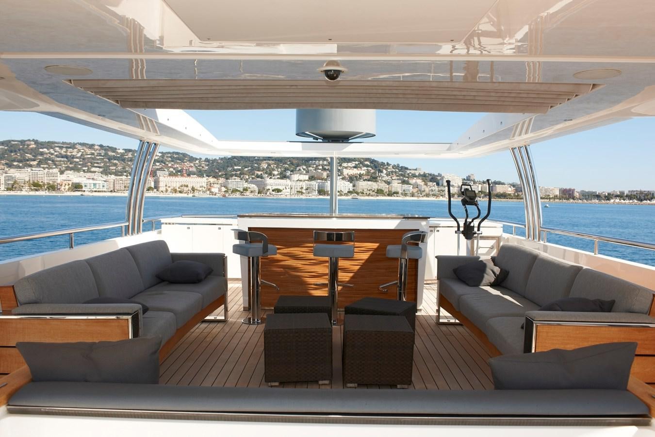 a room with a couch and a table and a view of a city aboard IMPERIAL PRINCESS BEATRICE Yacht for Sale