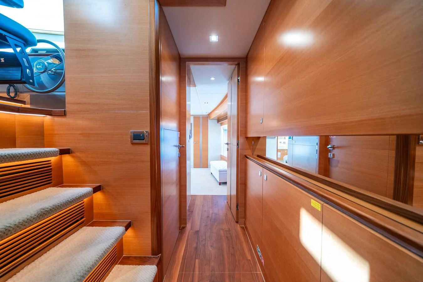 a wood room with a wood floor and a staircase aboard MIDNIGHT MOON Yacht for Sale