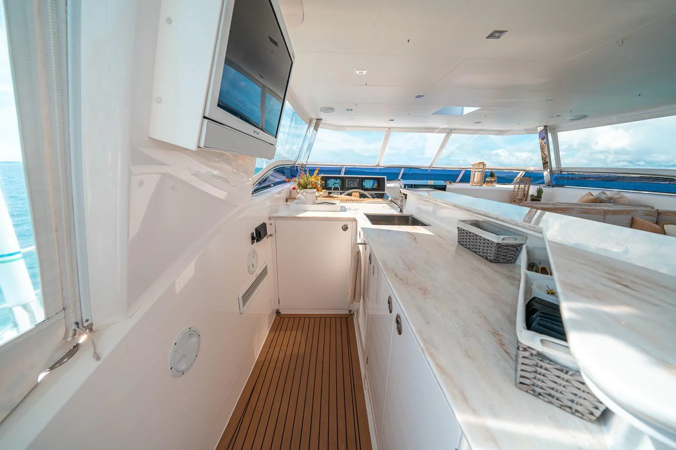 a kitchen with a wood floor aboard MIDNIGHT MOON Yacht for Sale