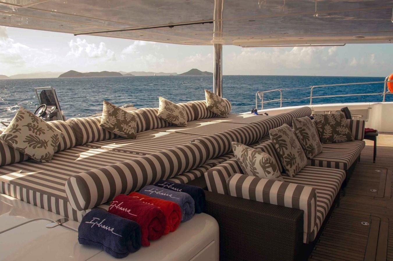 a couch with pillows and pillows aboard IPHARRA Yacht for Sale