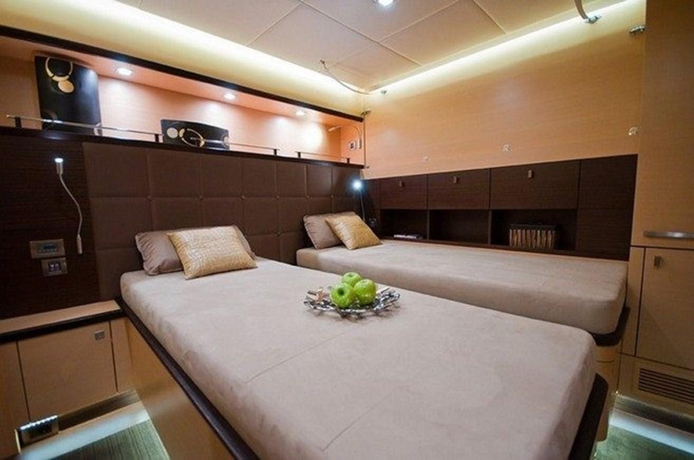 a large bed with a white table aboard IPHARRA Yacht for Sale