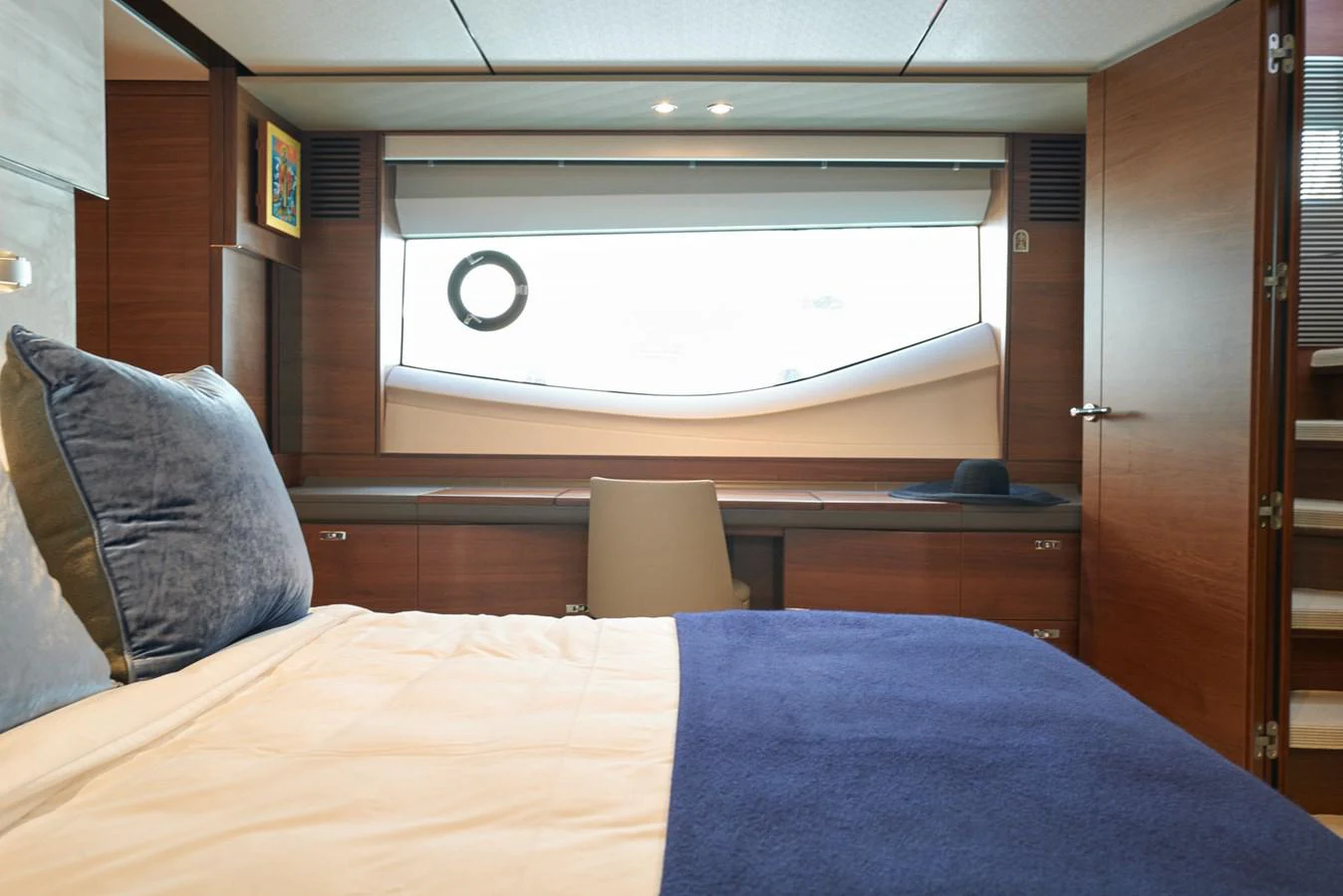 a bed with a pillow and a lamp on it aboard PRINCESS M Yacht for Sale