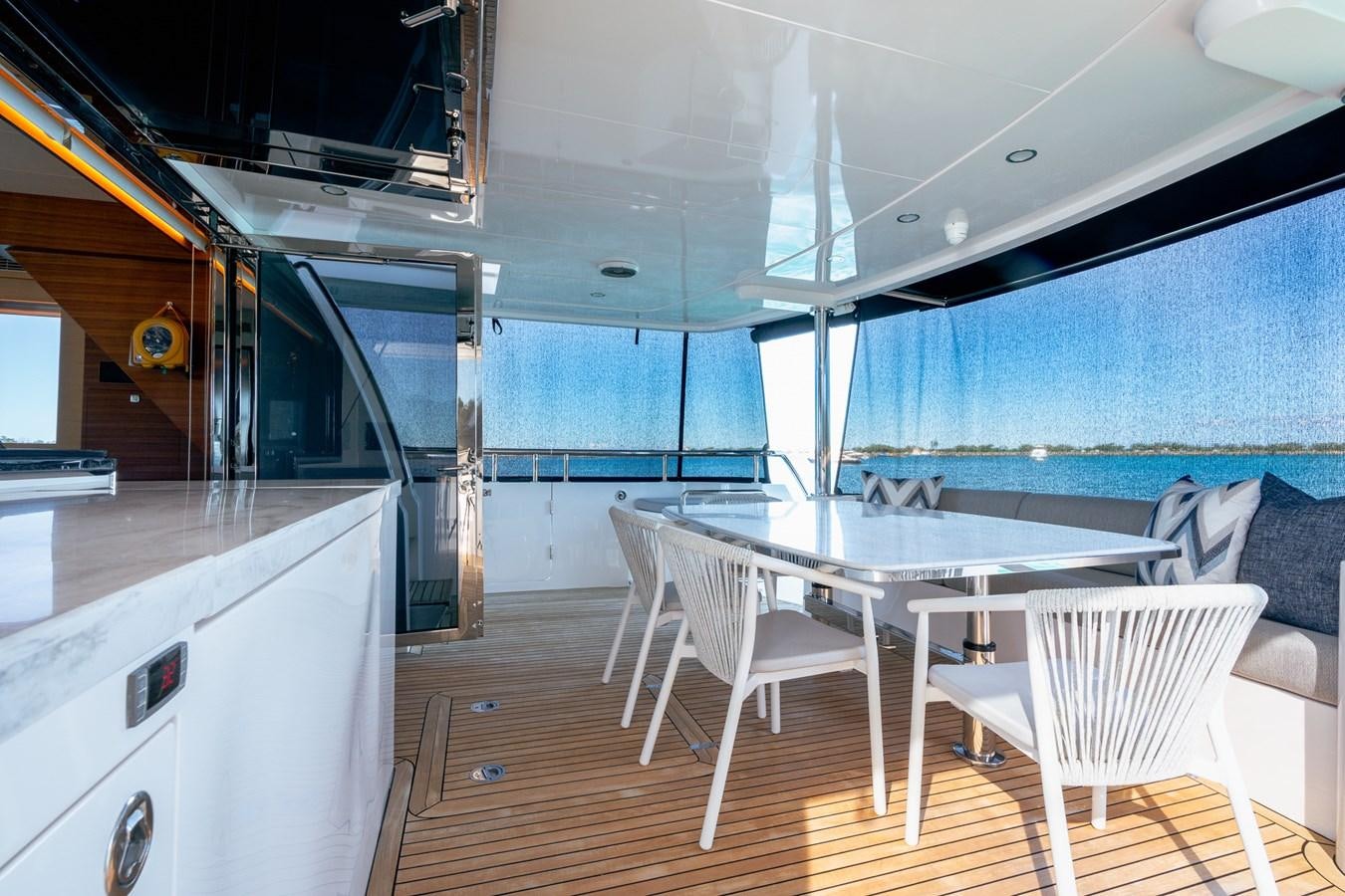 a kitchen with a table and chairs aboard LEGGERA Yacht for Sale