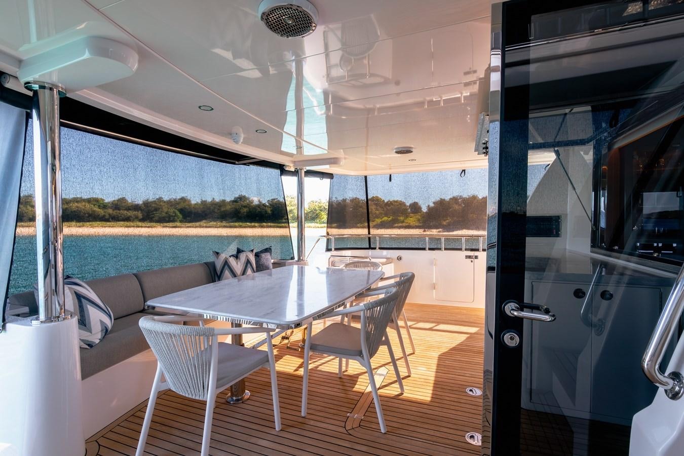 a table and chairs on a boat aboard LEGGERA Yacht for Sale