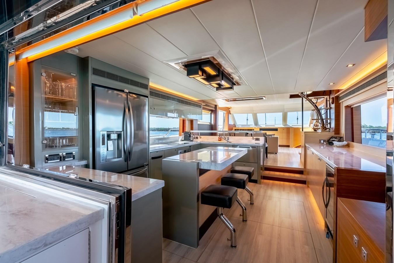 a kitchen with a large island aboard LEGGERA Yacht for Sale