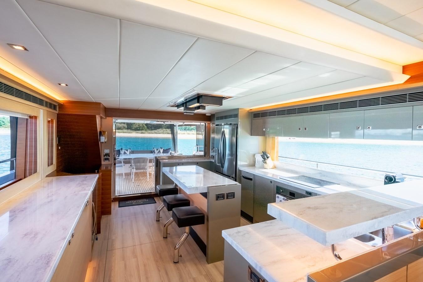 a kitchen with a table and chairs aboard LEGGERA Yacht for Sale