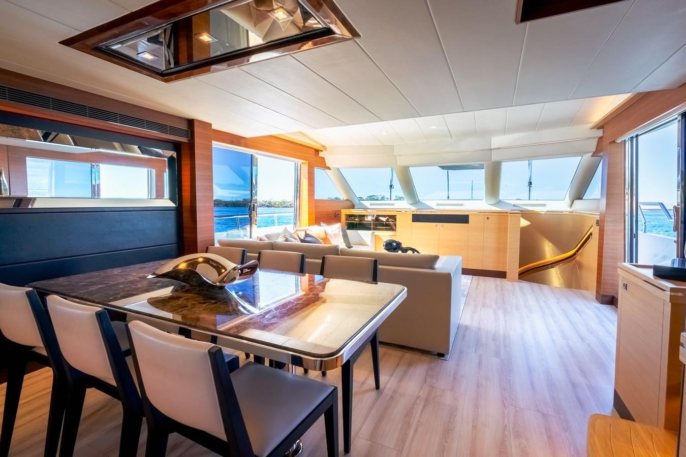 a large kitchen with a dining table aboard LEGGERA Yacht for Sale