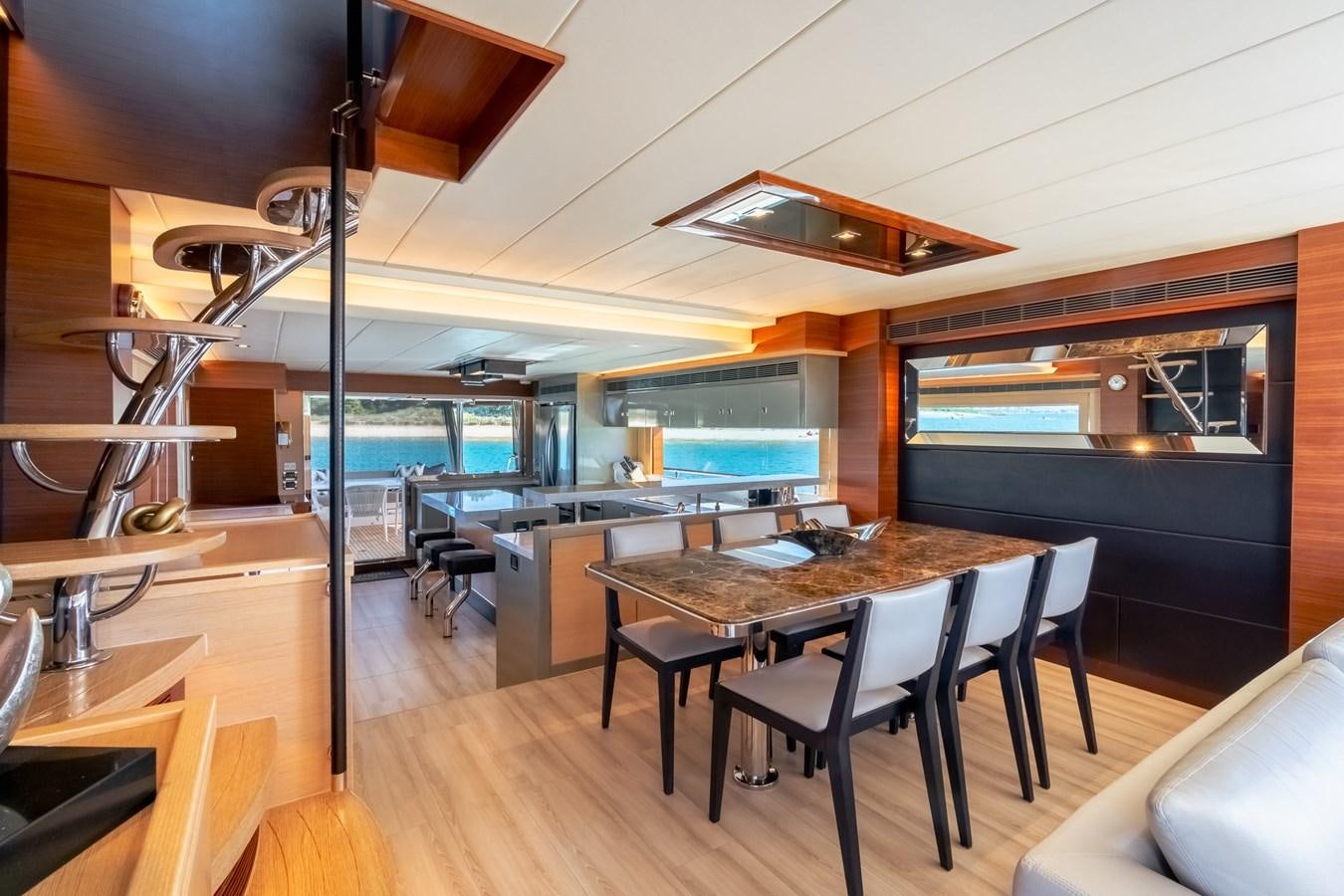 a room with a table and chairs aboard LEGGERA Yacht for Sale