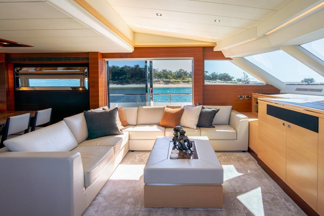 a living room with a couch and a table aboard LEGGERA Yacht for Sale
