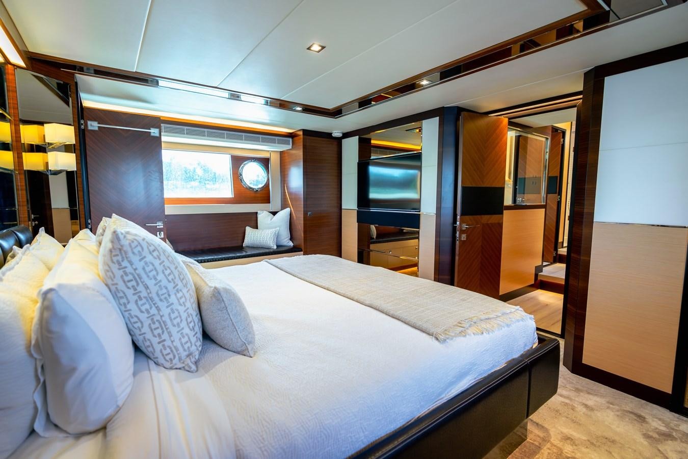 a room with a bed and a mirror aboard LEGGERA Yacht for Sale