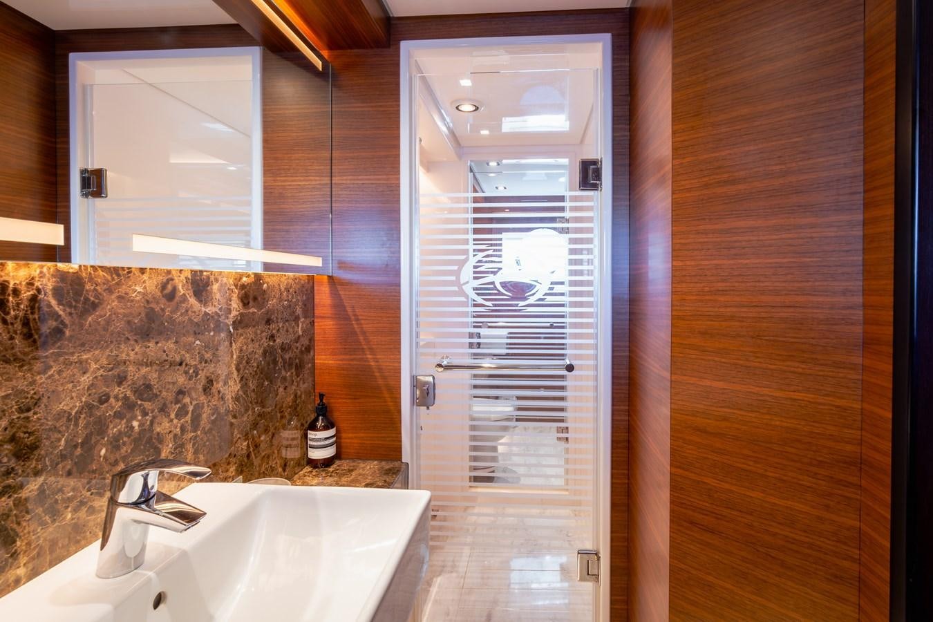 a bathroom with a glass shower door aboard LEGGERA Yacht for Sale
