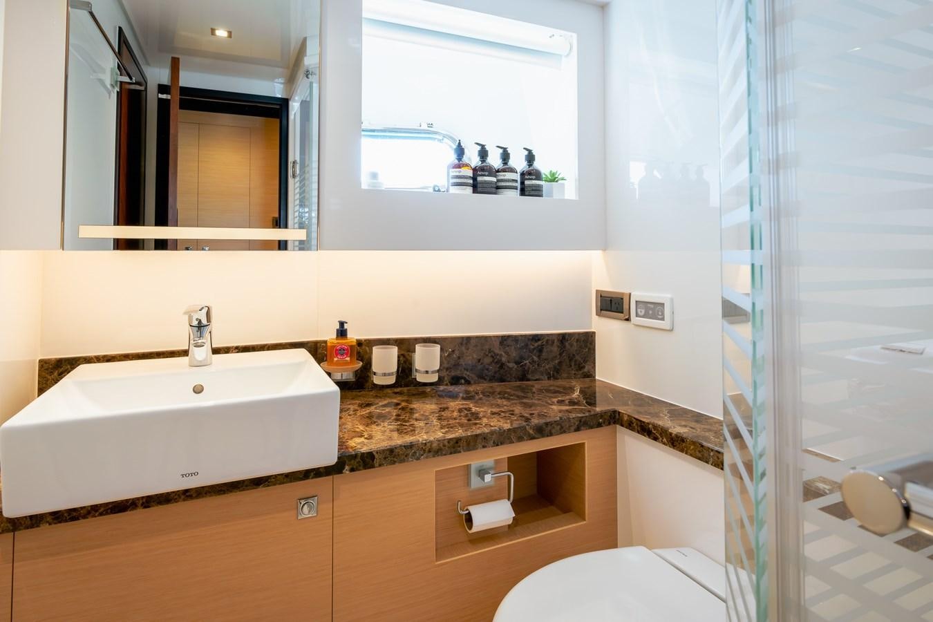 a bathroom with a sink and a mirror aboard LEGGERA Yacht for Sale