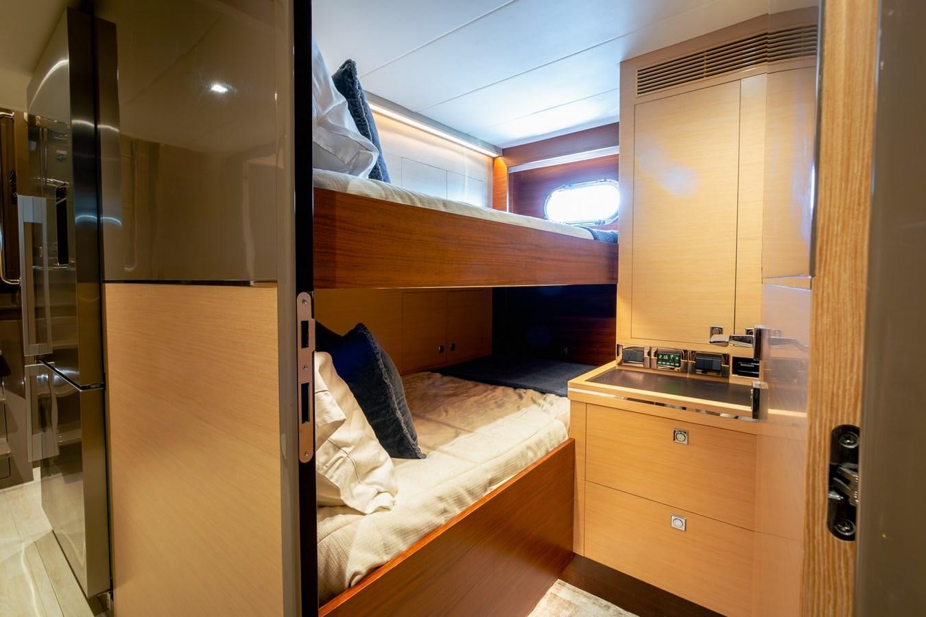 a room with a bed and a desk aboard LEGGERA Yacht for Sale