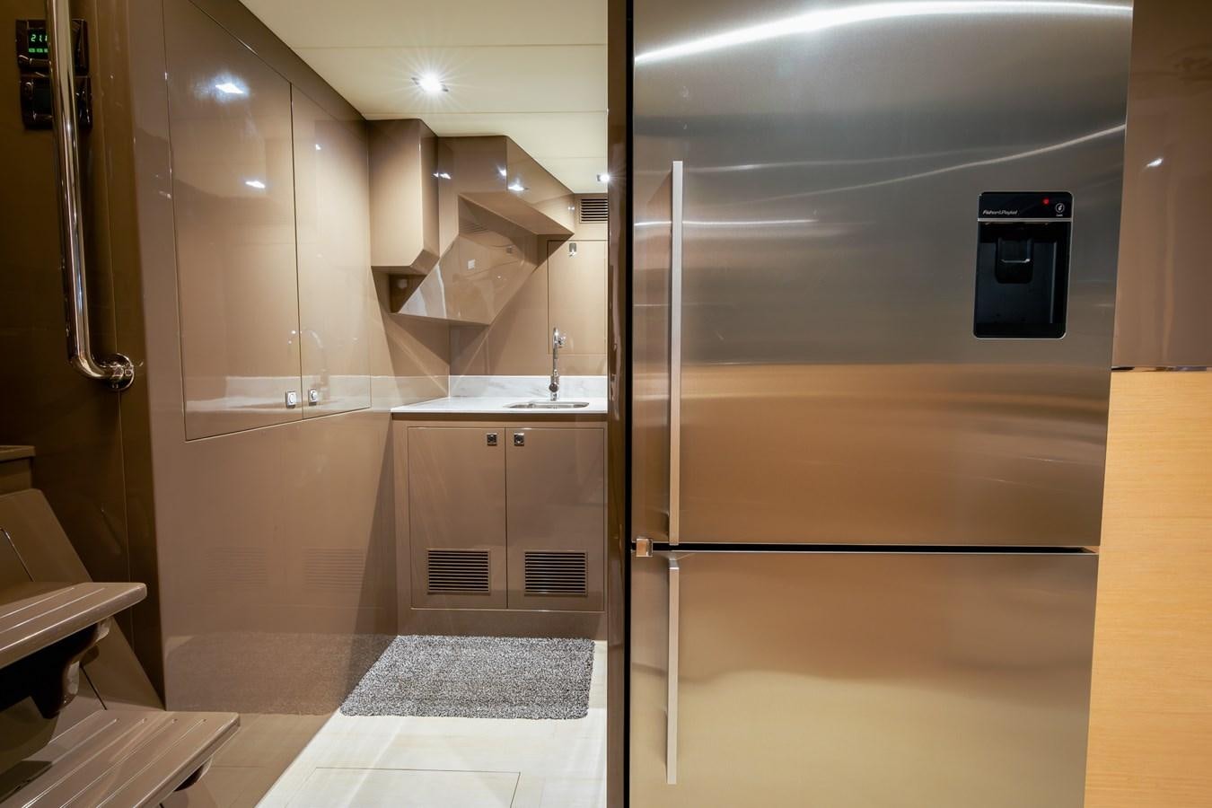 a large kitchen with a large refrigerator aboard LEGGERA Yacht for Sale