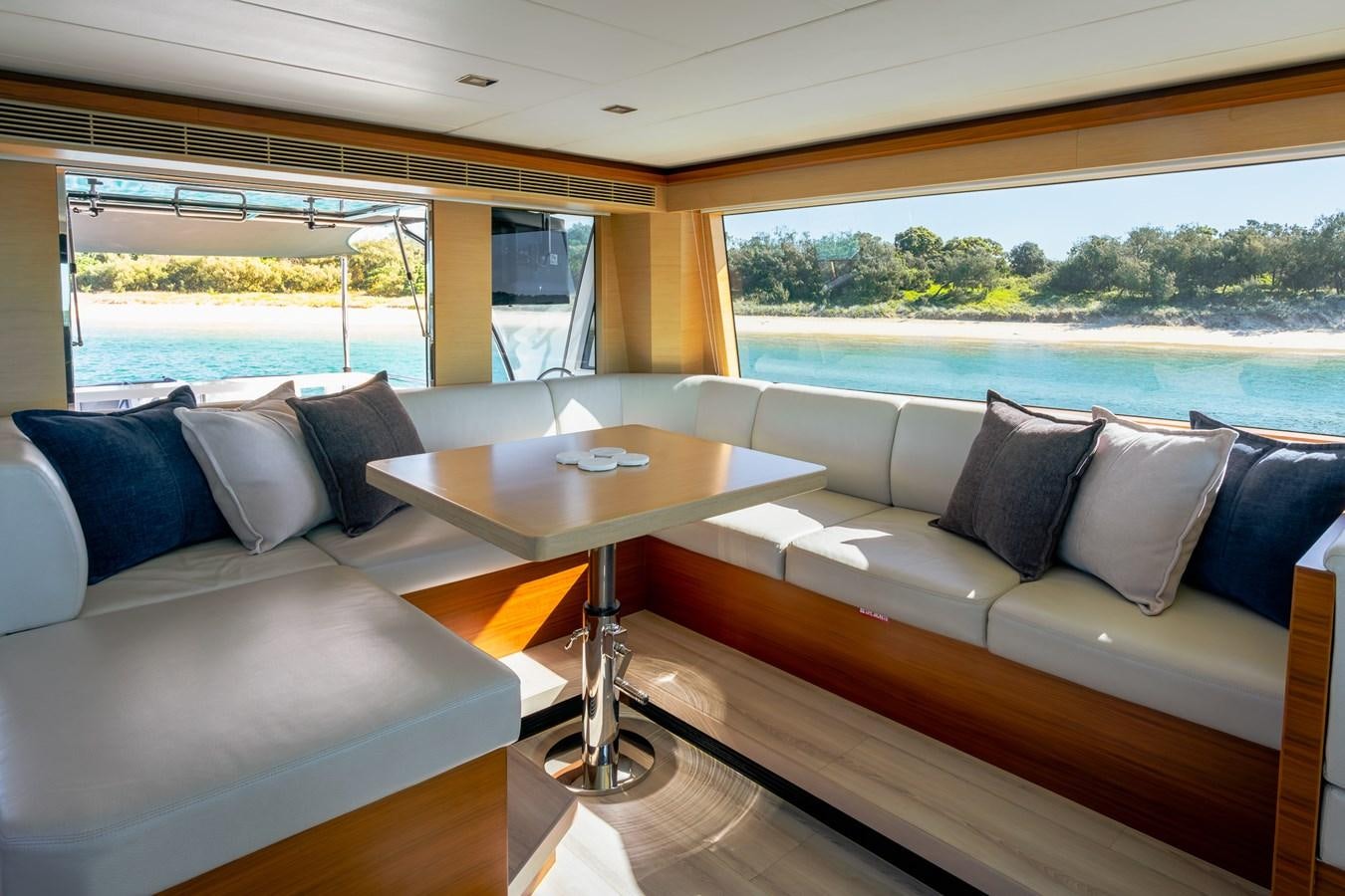 a living room with a couch and a table aboard LEGGERA Yacht for Sale