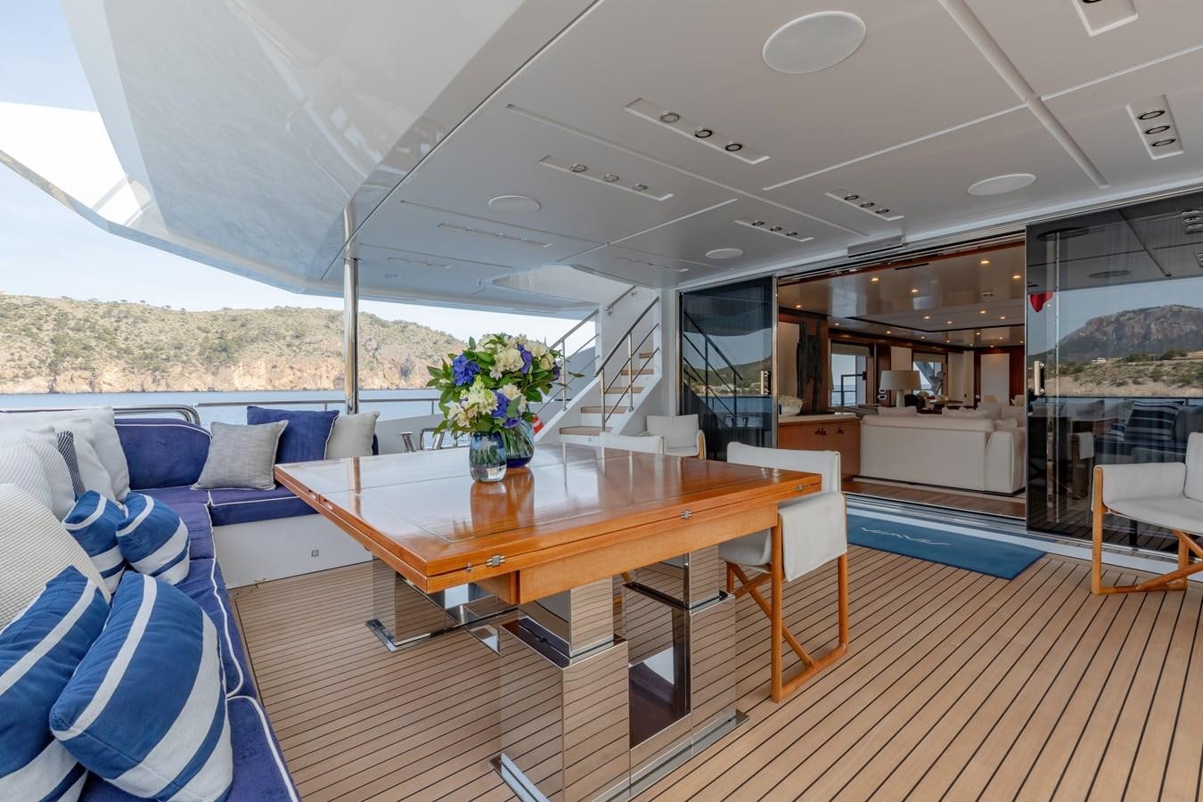 a large open space with a table and chairs and a large window aboard NEW WAVES Yacht for Sale