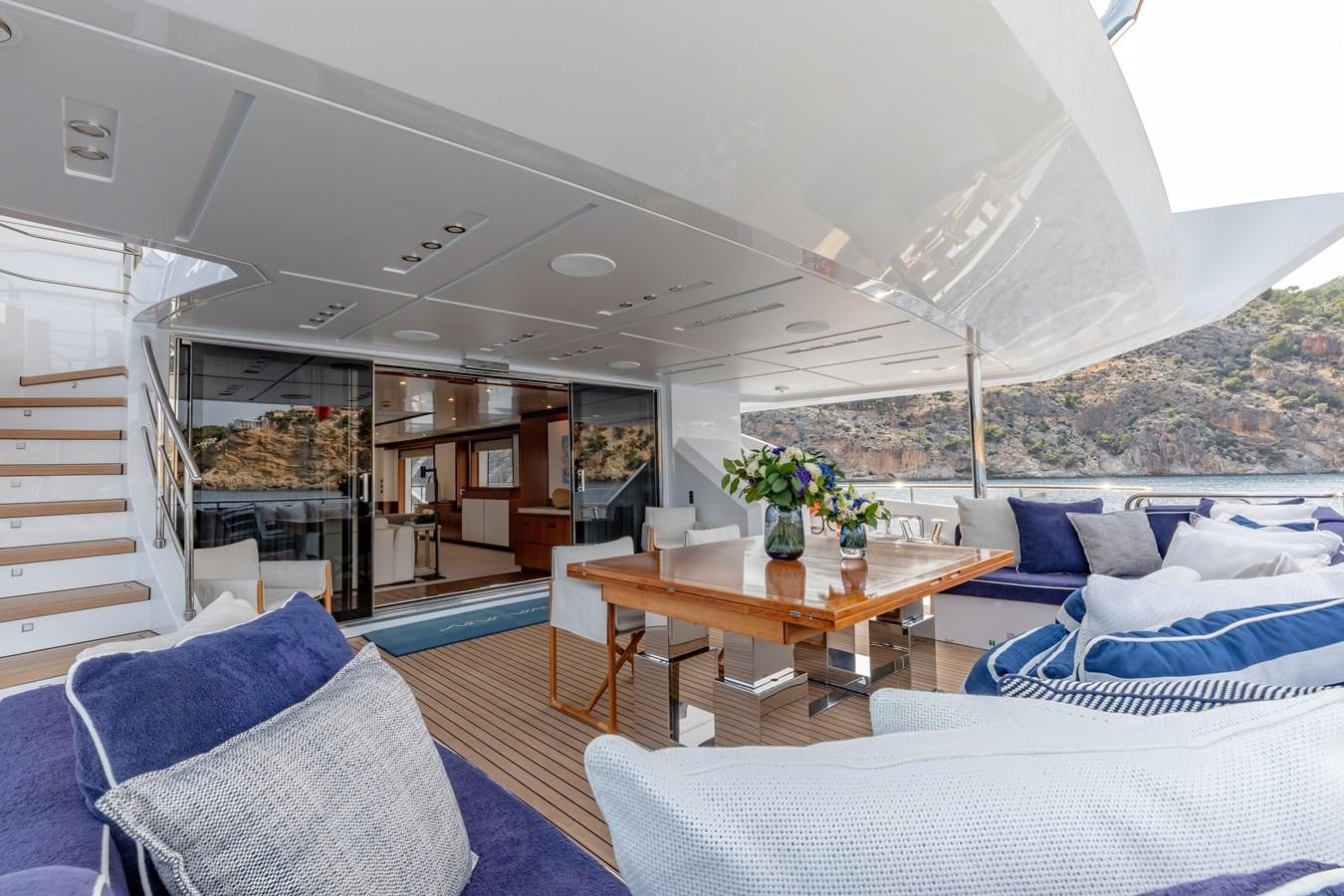 a room with a table and couches aboard NEW WAVES Yacht for Sale