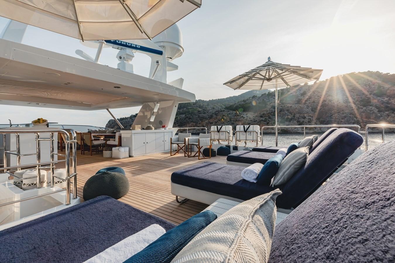 a tent with a couch and umbrella aboard NEW WAVES Yacht for Sale