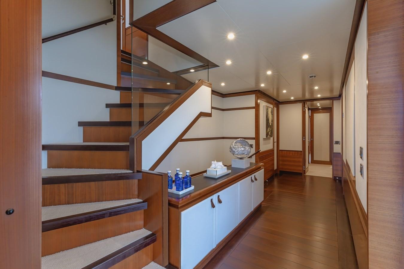 a room with a wood floor and a staircase aboard NEW WAVES Yacht for Sale
