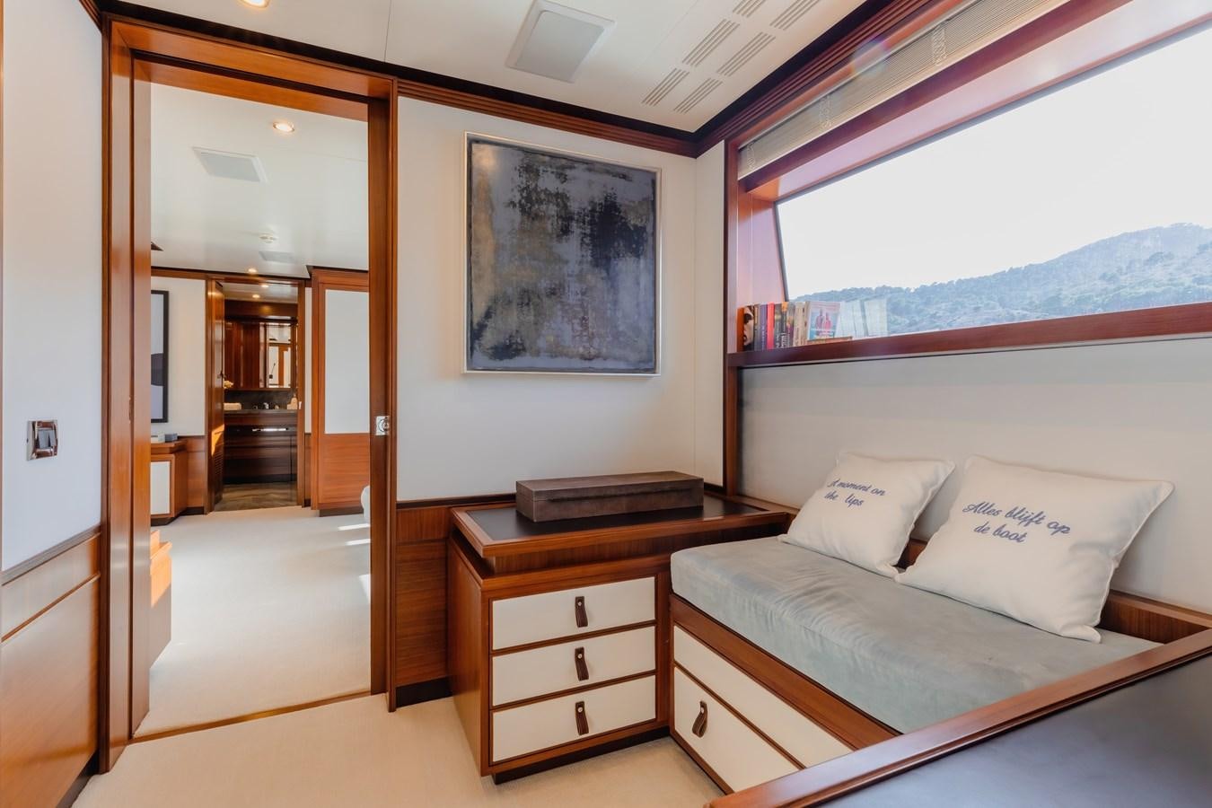 a bedroom with a bed and a dresser aboard NEW WAVES Yacht for Sale