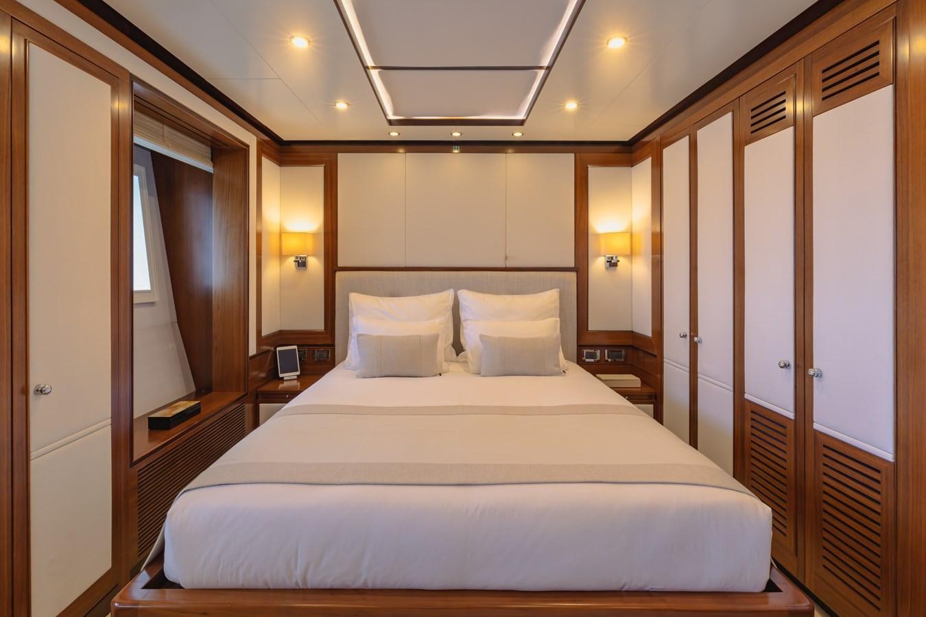 a large bed in a hotel room aboard NEW WAVES Yacht for Sale