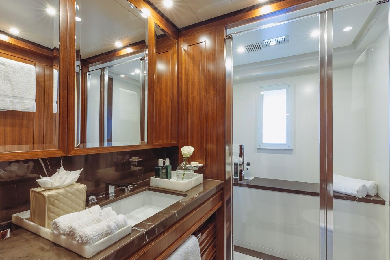 a bathroom with a large mirror aboard NEW WAVES Yacht for Sale