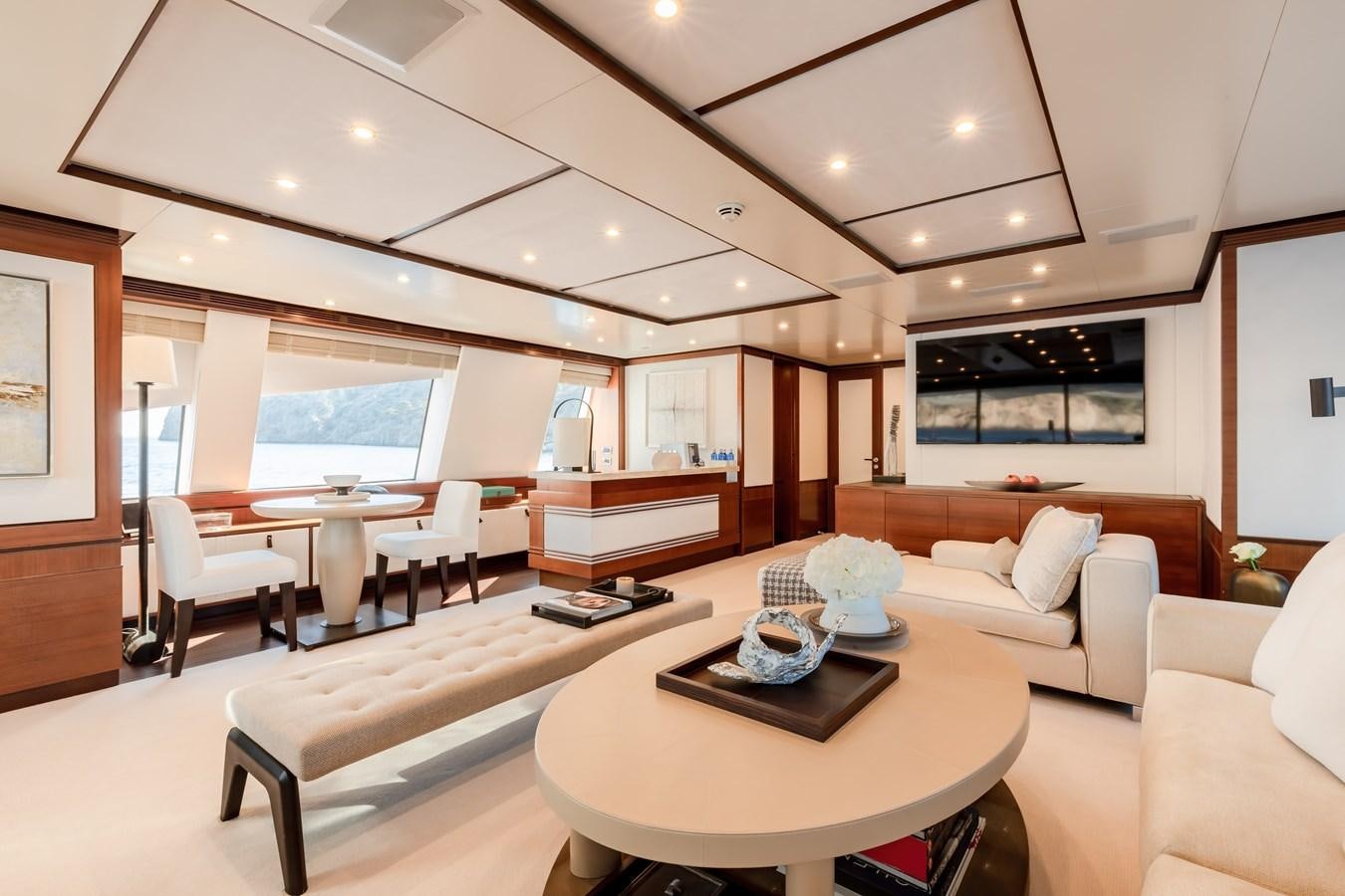 a living room with a table and couches aboard NEW WAVES Yacht for Sale