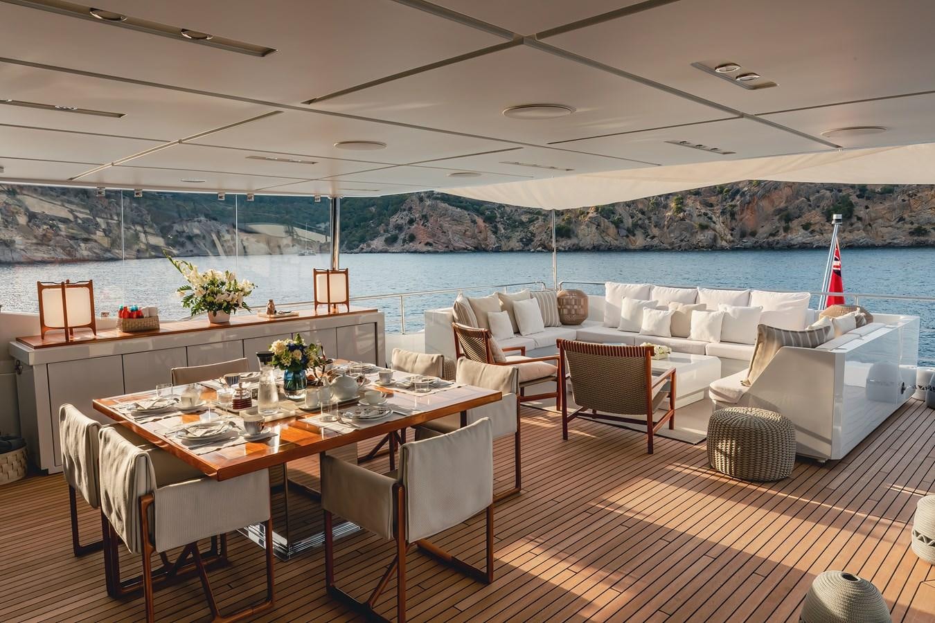 a room with a table chairs and a view of the ocean aboard NEW WAVES Yacht for Sale