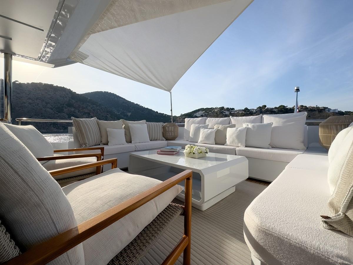a living room with a couch and a table aboard NEW WAVES Yacht for Sale