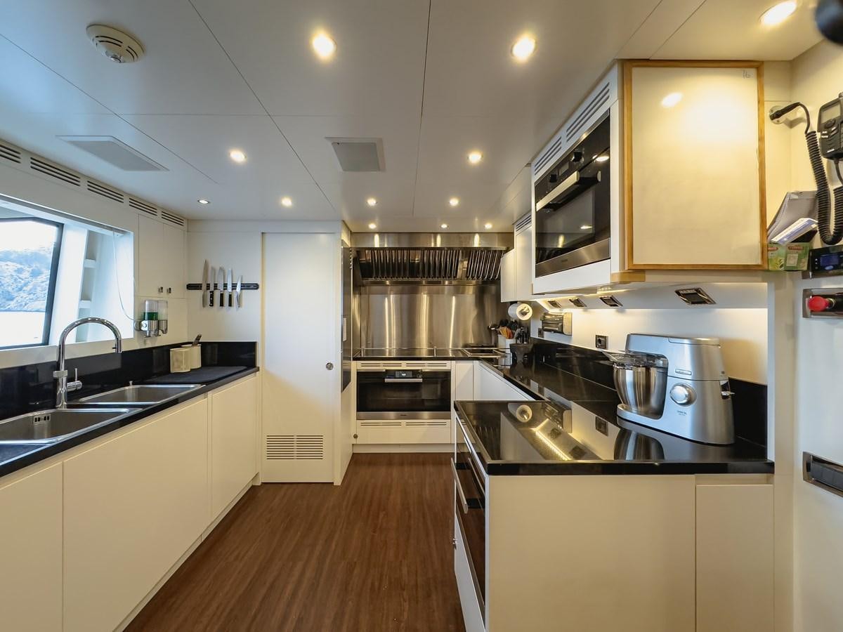a kitchen with a microwave oven and stove aboard NEW WAVES Yacht for Sale