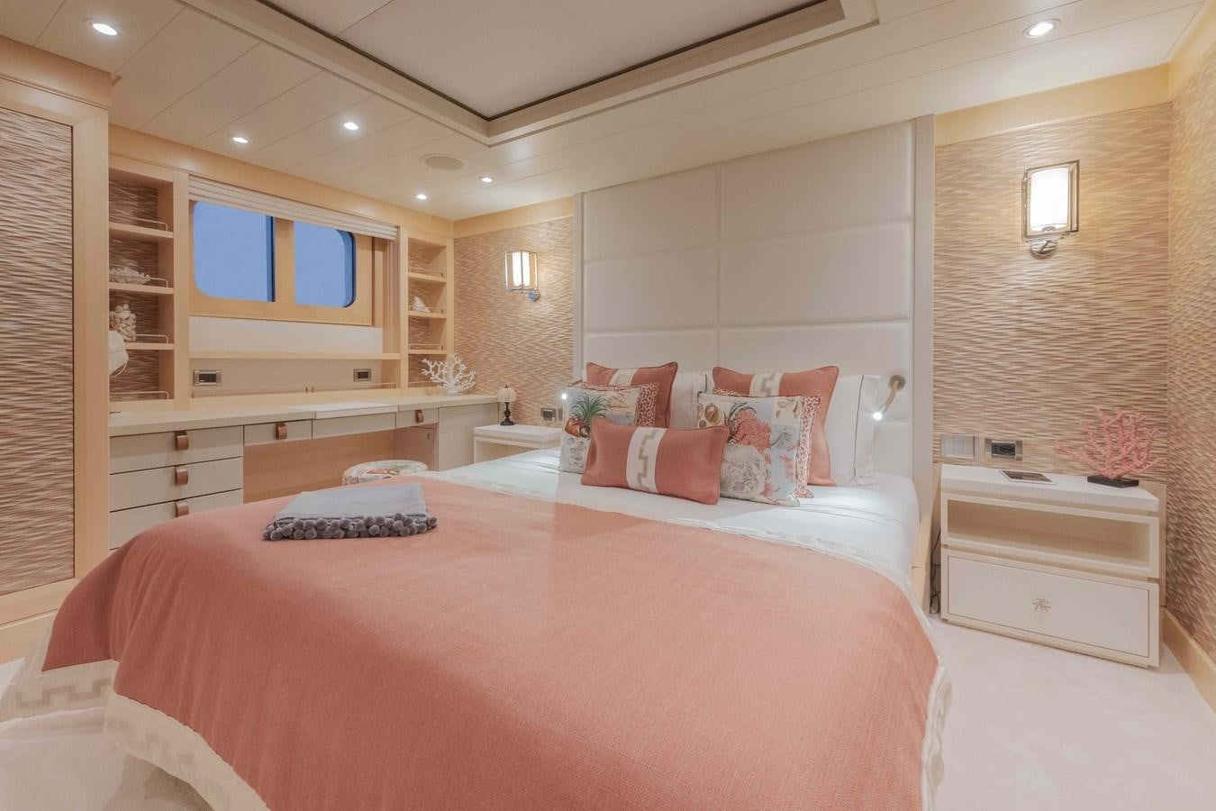 a bedroom with a bed and a desk aboard SPIRIT Yacht for Sale