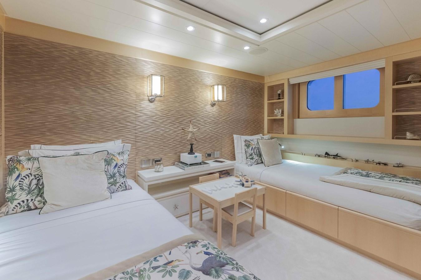 a room with a bed and a table aboard SPIRIT Yacht for Sale