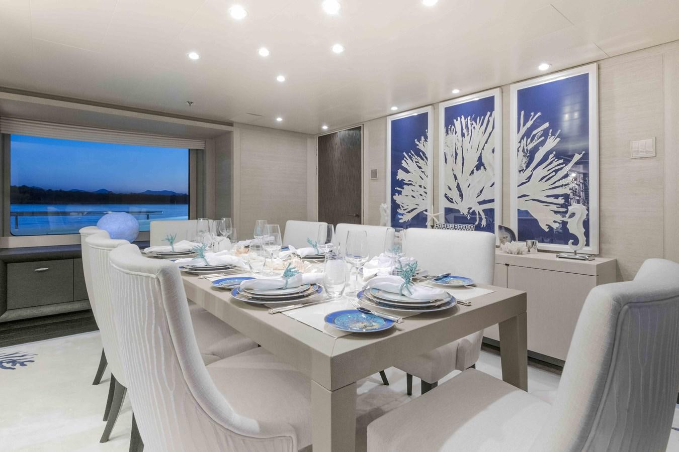 a conference room with white chairs and a large screen aboard SPIRIT Yacht for Sale