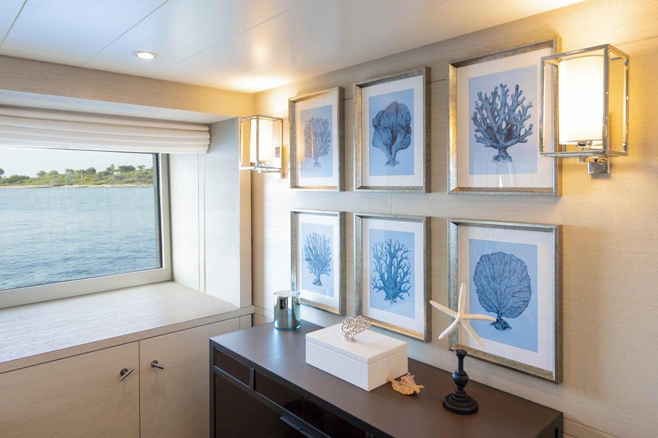 a room with paintings on the wall aboard SPIRIT Yacht for Sale