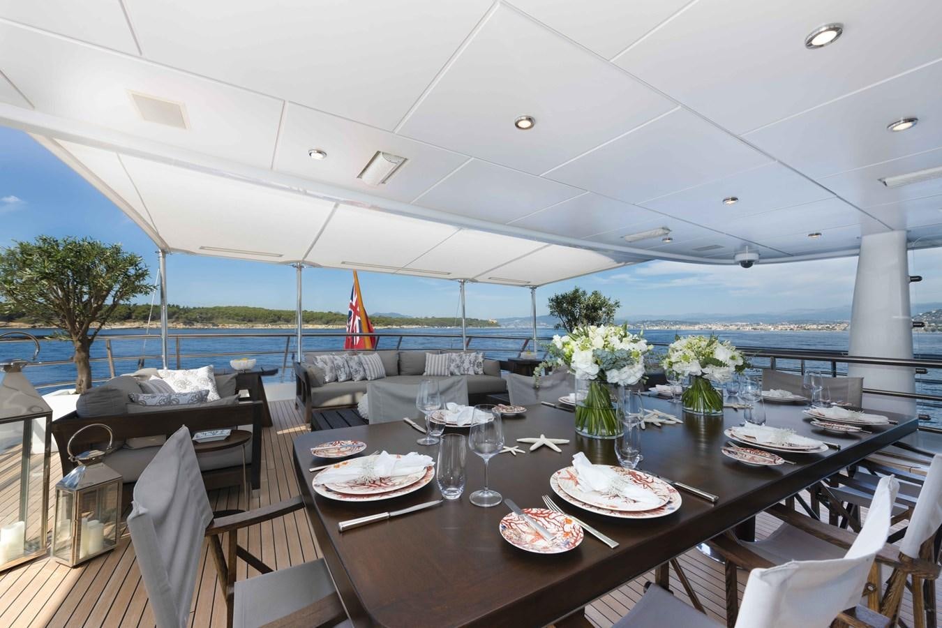 a table with plates and glasses aboard SPIRIT Yacht for Sale