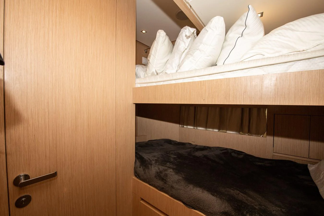 a cat lying on a bed aboard OUR ALEPH Yacht for Sale
