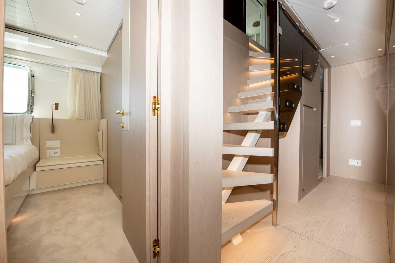 a hallway with a staircase and a couch aboard OUR ALEPH Yacht for Sale