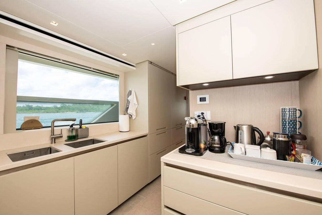 a kitchen with white cabinets aboard OUR ALEPH Yacht for Sale