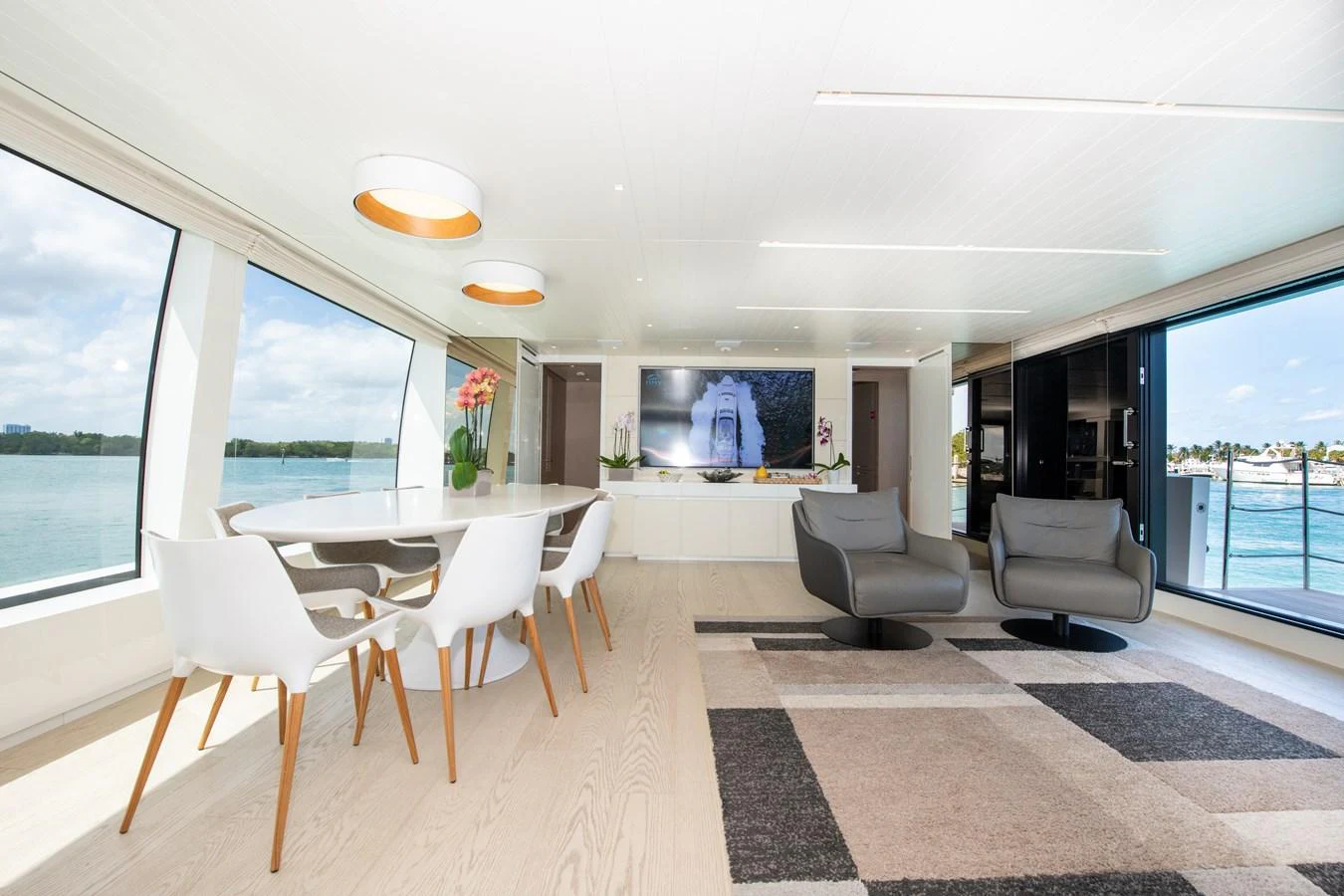 a room with a table chairs and a tv aboard OUR ALEPH Yacht for Sale