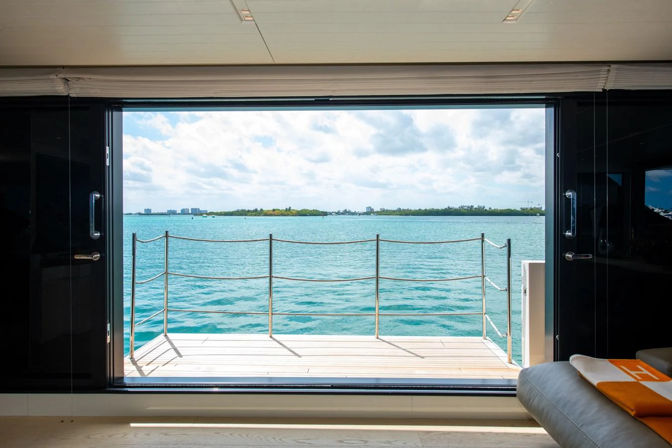 a view of a beach from a balcony aboard OUR ALEPH Yacht for Sale