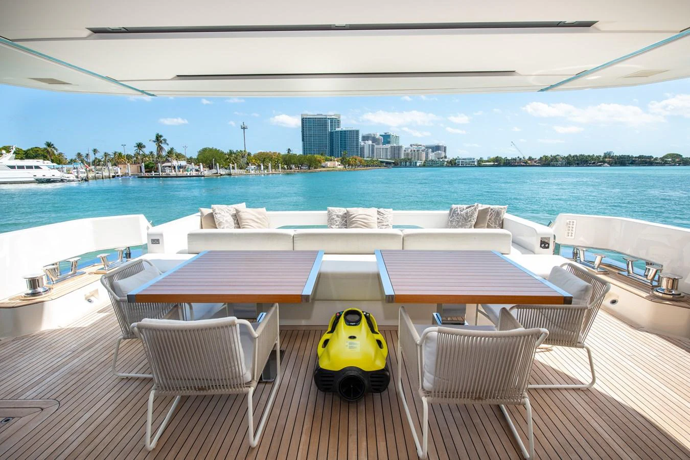a table and chairs on a deck overlooking a body of water aboard OUR ALEPH Yacht for Sale