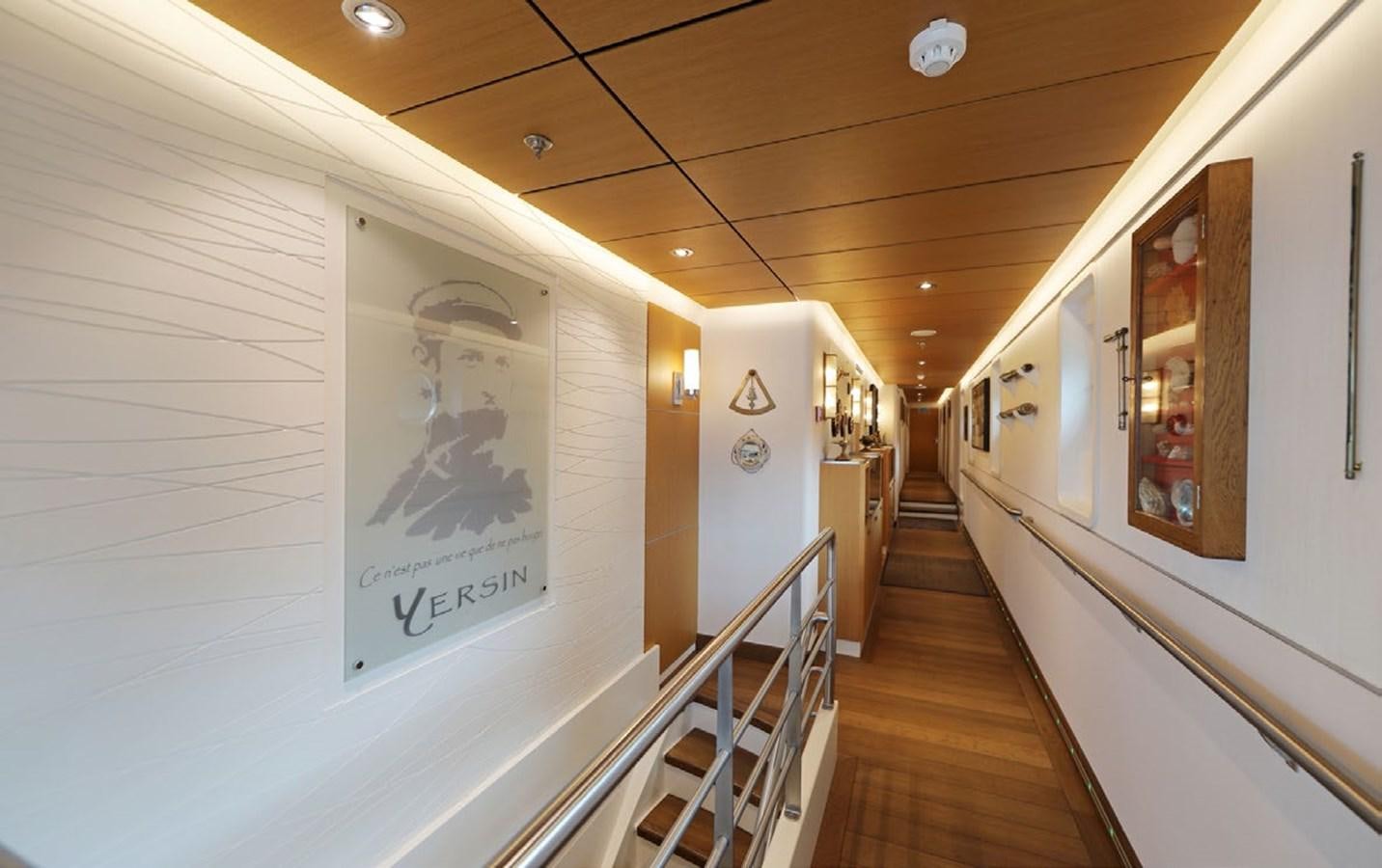 a hallway with art on the wall aboard YERSIN Yacht for Sale