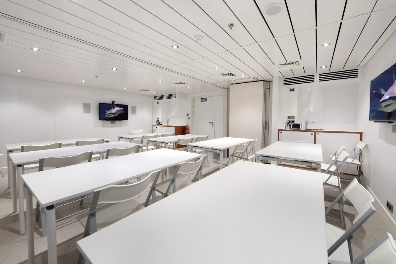 a room with tables and chairs aboard YERSIN Yacht for Sale