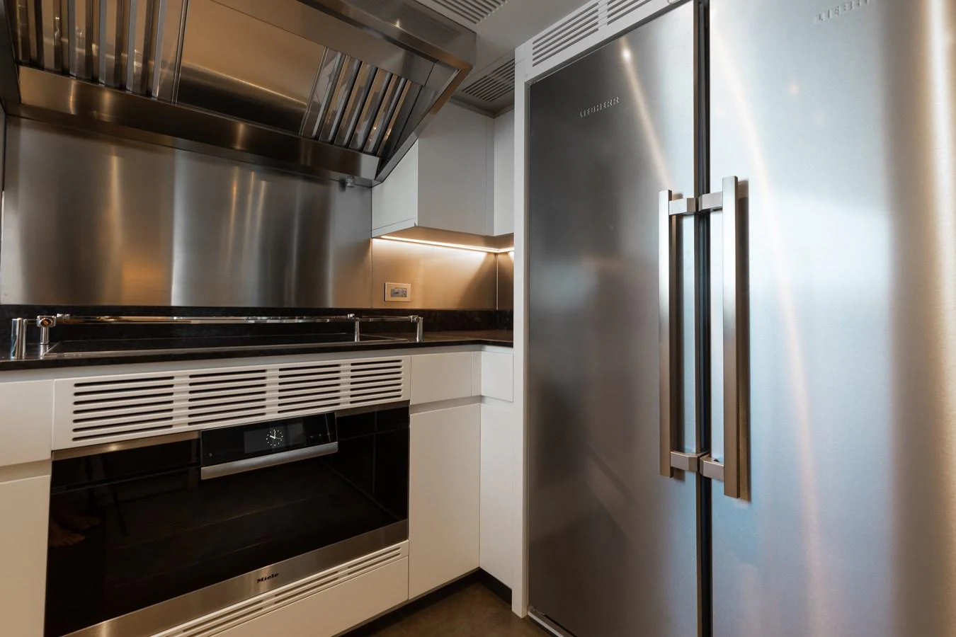 a kitchen with stainless steel appliances aboard ABBENTURES III Yacht for Sale