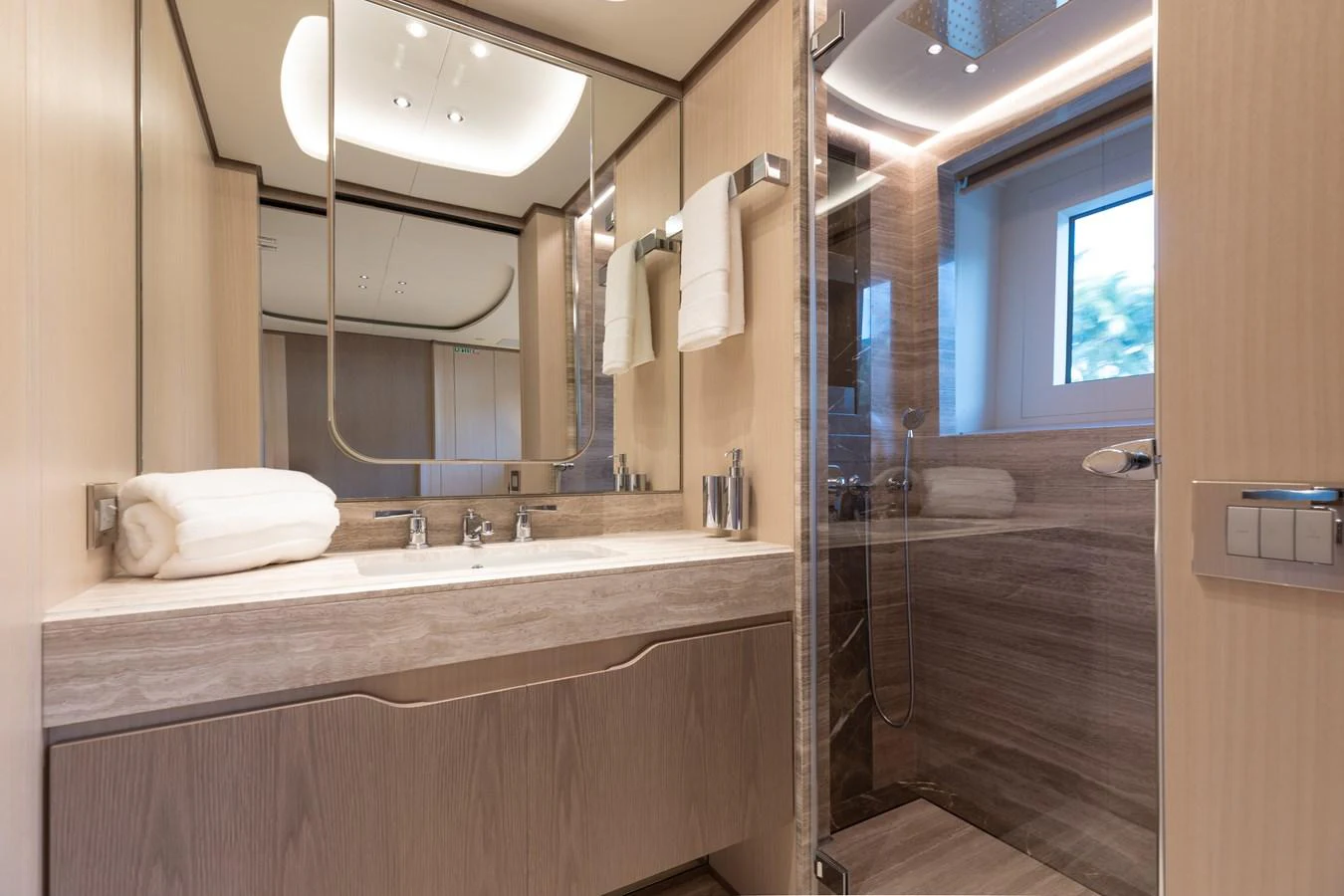 a bathroom with a large mirror aboard ABBENTURES III Yacht for Sale
