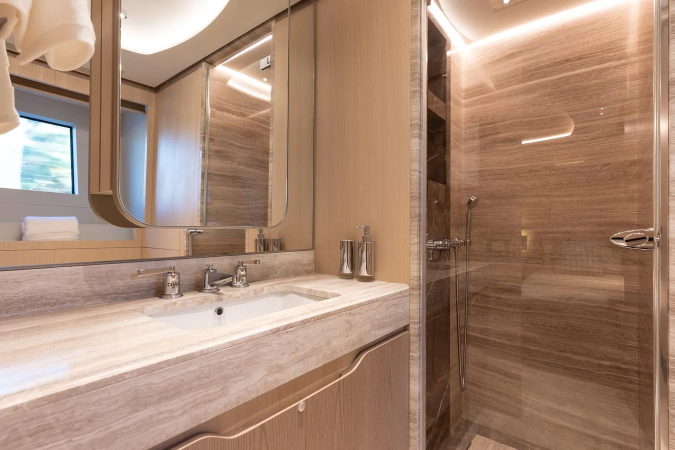 a bathroom with a large mirror aboard ABBENTURES III Yacht for Sale