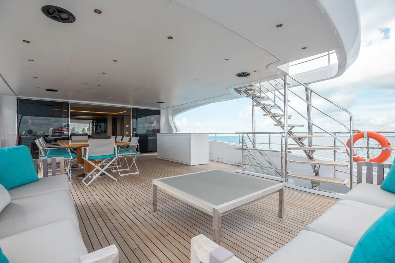 a room with a staircase and a table and chairs aboard ABBENTURES III Yacht for Sale